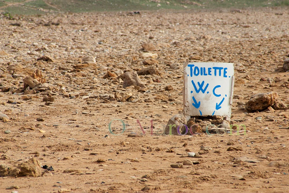 Un trou dans le sable avec une pancarte