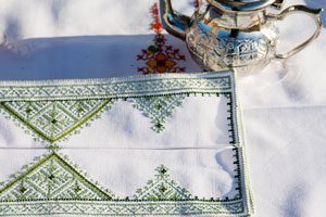 Fez stitch place mat, green, and teapot
